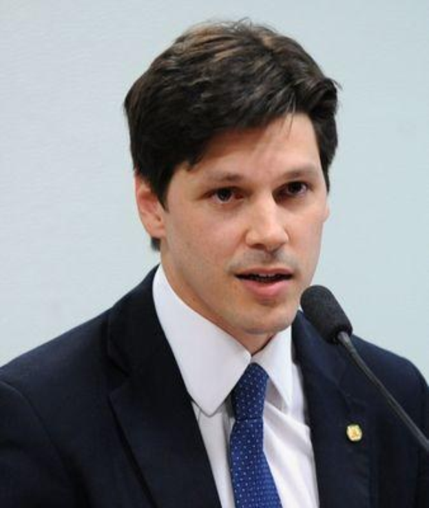 Ein Mann im Anzug spricht in ein Mikrofon, wahrscheinlich um die Genehmigung eines Gesetzes zur Verbots des Internetgebrauchs durch die Regierung zu kommentieren.