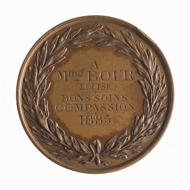 Bronze-Medaille mit Lorbeerkranz-Design, das den Text "Bons Soins Compassion" auf einem wei├čen Hintergrund zeigt.